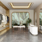 Innenraum eines Boutique-Showrooms mit goldenen Akzenten, hellem Fassadendesign, Wandpaneelen, Kleiderschrank, Marmor, und tropischem Wandmotiv im Hintergrund